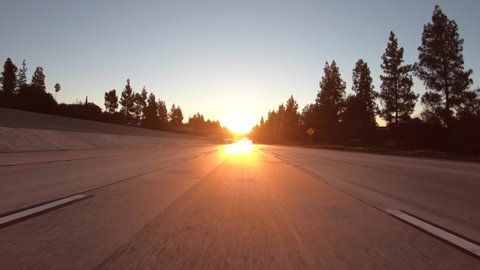 Sunrise driving on 210 freeway east in the La Canada Flintridge area of Los Angeles County, California.