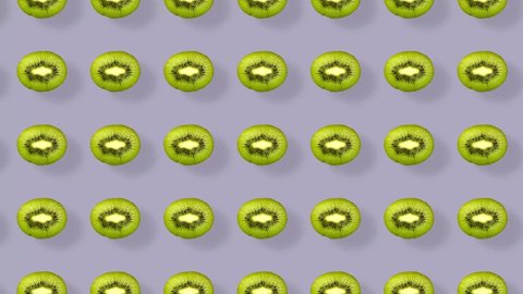 Colorful pattern of kiwi. Top view. Minimal tropical fruit concept. Seamless pattern with kiwi sliced. Realistic animation. 4K video motion