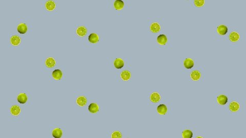 Colorful fruit pattern of fresh rotating green limes on grey background. Seamless pattern with lime. Realistic animation. 4K video motion
