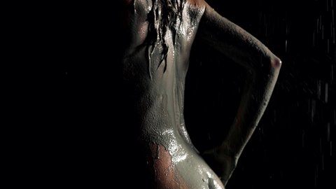 woman in shower, washing off clay from her skin and hair, sensual and sexy shot of female body in darkness, silhouette of slender figure