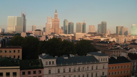 Ascending footage of downtown skyscrapers. Group of high rise office buildings in city centre in sunny morning. Warsaw, Poland