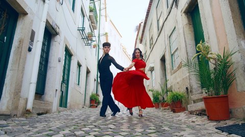 Beautiful Couple Dancing a Latin Dance on the Quiet Street of an Old Town in a City. Dance by Two Professional Dancers on a Sunny Day Outside in Ancient Culturally Rich Tourist Location.