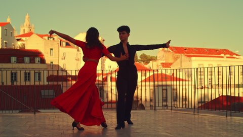 Beautiful Couple Dancing a Latin Dance Outside the City with Old Town in the Background. Dance by Two Professional Dancers on a Sunset in Ancient Culturally Rich Tourist Location.