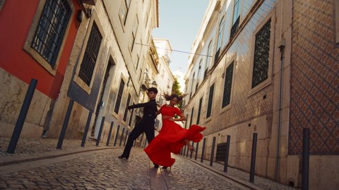 Beautiful Couple Dancing a Latin Dance on the Quiet Street of an Old Town in a City. Dance by Two Professional Dancers on a Sunny Day Outside in Ancient Culturally Rich Tourist Location.