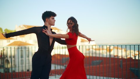 Beautiful Couple Dancing a Latin Dance Outside the City with Old Town in the Background. Dance by Two Professional Dancers on a Sunset in Ancient Culturally Rich Tourist Location.