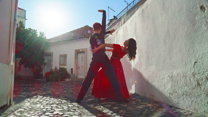 Beautiful Couple Dancing a Latin Dance on the Quiet Street of an Old Town in a City. Dance by Two Professional Dancers on a Sunny Day Outside in Ancient Culturally Rich Tourist Location.