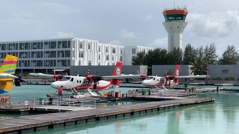 Male, Maldives - November 8 2021: Passengers boarding a DHC-6 Twin Otter Turboprop Seaplane from Trans Maldivian Airways at Maldivian Seaplane Terminal