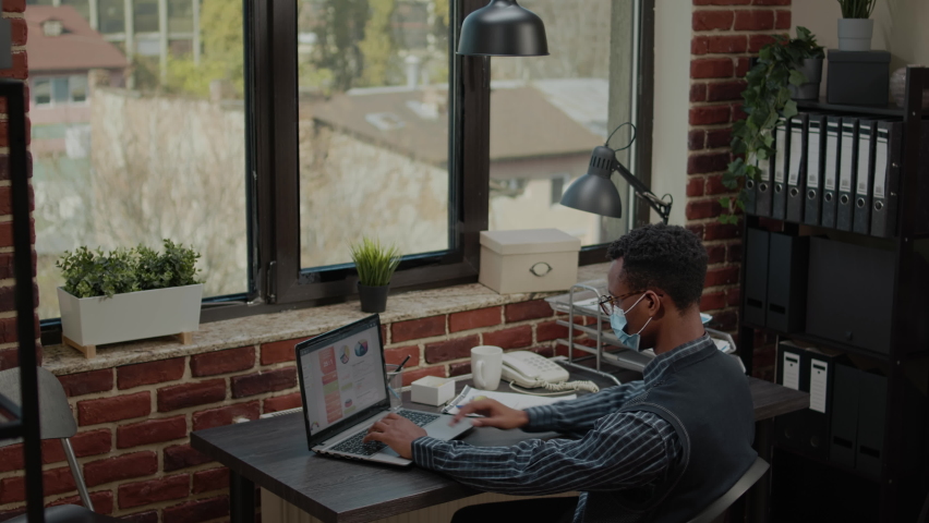 Business man working on financial management in startup office. Company employee with face mask planning commercial development to create e business investment. Project manager - Powered by Shutterstock - Get 15% off with code: PIKWIZARD15