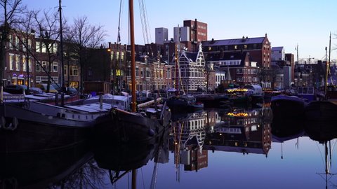 GRONINGEN - THE NETHERLANDS, December 21, 2021: Reflections during blue hour at the Noorderhaven in the city of Groningen.