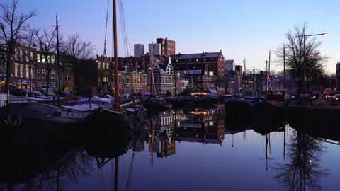 GRONINGEN - THE NETHERLANDS, December 21, 2021: Reflections during blue hour at the Noorderhaven in the city of Groningen.