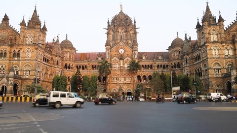 Mumbai, Maharashtra, India - 3rd Jan, 2022 : Real time still video of vehicle traffic outside Chhatrapati Shivaji Terminus (CST) Railway station building during sunset. It is an UNESCO Heritage Site.