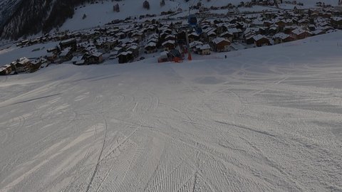 Livigno, Italy - December 29, 2021 - helmet-camera POV view of downhill skier entering the town of Livigno