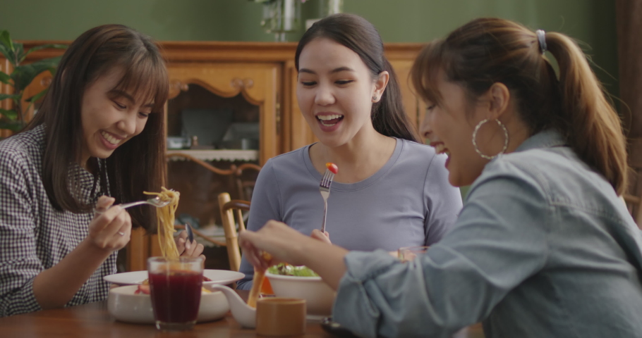 Asia people success young teen girl female group taste tasty buffet dining sit talk or share in youth culture social joy cozy relax leisure dinner hour party guest at reopen indoor casual cafe bar. Royalty-Free Stock Footage #1084931581