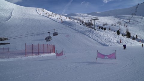 Livigno, Italy - December 29, 2021 - skiers and snowboarders arriving at ski lift