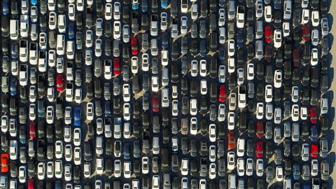 Aerial Descending Directly Over A Parking Lot Of Many Cars Crowded Into Tandem Lanes - Los Angeles, California