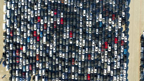 Aerial Descending Directly Over A Parking Lot Full Of Many Cars Crowded Into Tandem Lanes - Los Angeles, California