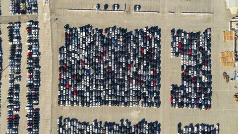 Aerial Rising Directly Over A Parking Lot Of Many Cars Crowded Into Tandem Lanes - Los Angeles, California