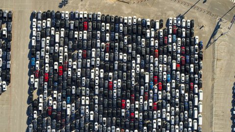 Aerial Descending Over A Parking Lot Of Many Cars Crowded Into Tandem Lanes - Los Angeles, California