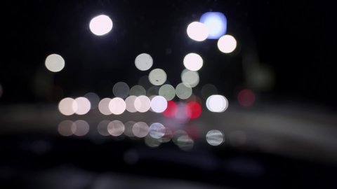 Bokeh of cars and traffic lights at night. Bokeh of small european City Night Traffic. Round colorful bokeh shine from car lights in traffic jam on city street