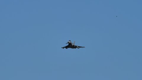 Thiene Italy OCTOBER, 16, 2021 Military combat aircraft with full afterburner in the blue sky. Eurofighter Typhoon canard delta wing multirole fighter jet of Italian air Force