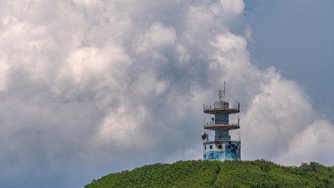 Old telecommunications tower on a hilltop near Noumea, New Caledonia - time lapse with dynamic cloudscape