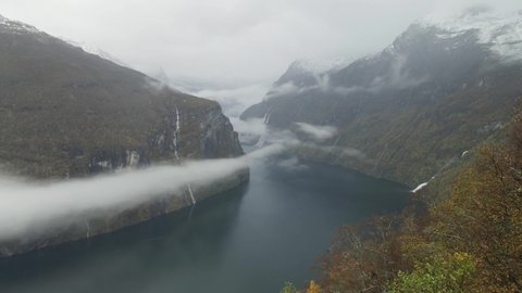 Aerial View Of Clouds Over Geirangerfjord Between Mountains With Waterfalls In Norway.