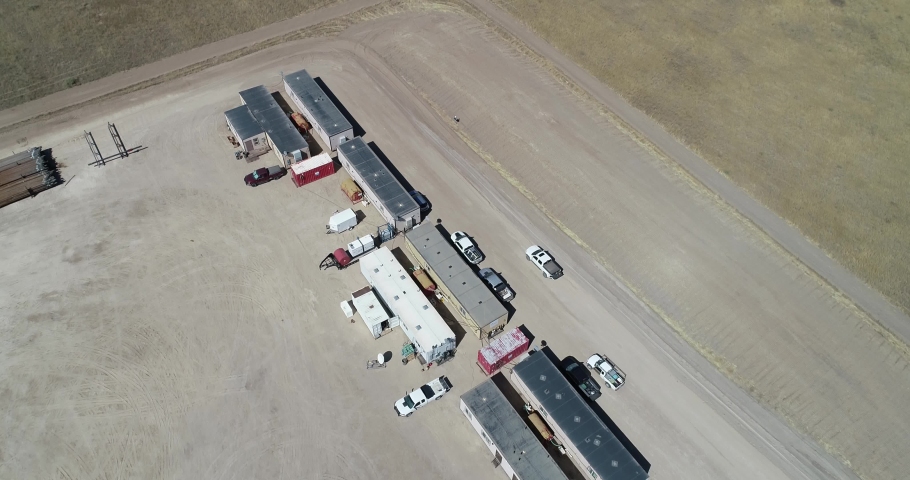 Operations buildings on a fracking pad drone flight back to reveal location on the great plains. | Shutterstock HD Video #1084944259