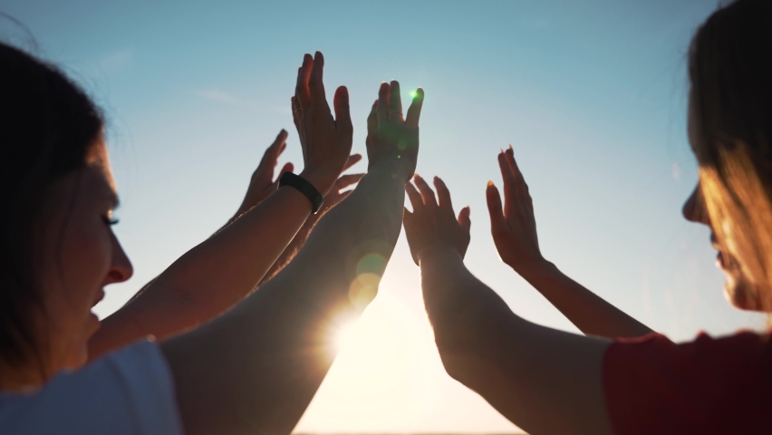 Group of people pulls their hands to sun sky. Teamwork religion and belief. Group of people stretch their hands up. Summer vacation and travel people. Team summer vacation. Group of friends teamwork | Shutterstock HD Video #1084944628