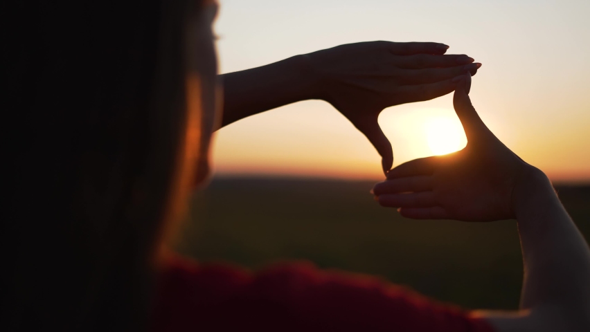 Business strategy. Girl folded her hands in frame at sunset. Silhouette of girl in natural park. Fingers at sunset. Work planning. Girl in field folded her hands into frame. Business planning concept. Royalty-Free Stock Footage #1084944634