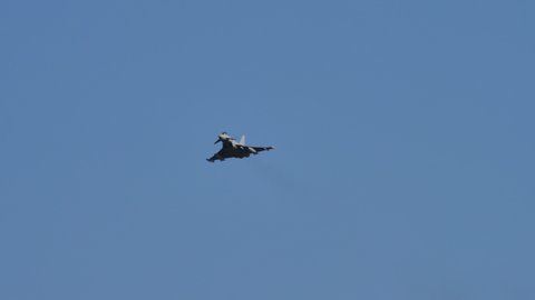 Thiene Italy OCTOBER, 16, 2021 Military combat jet in flight in blue sky with copy space. Eurofighter Typhoon twin-engine canard delta wing multirole fighter jet of Italian air Force