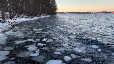 Ice floating in the cold dark water. Part of the Swedish lake Malaren or Mälaren. Winter 4K video in December. Stockholm, Sweden.