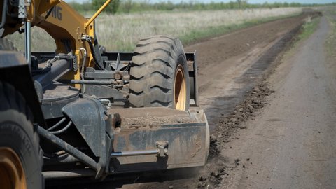September 3, 2021, Russia, Orenburg.
LiuGong 425-4WD CLG grader levels the ground with the bottom blade on a country road.