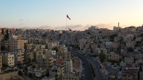 Aerial footage of Amman Jordan during the sunrise, above the city