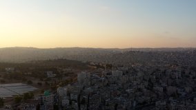Aerial footage of Amman Jordan during the sunrise, above the city