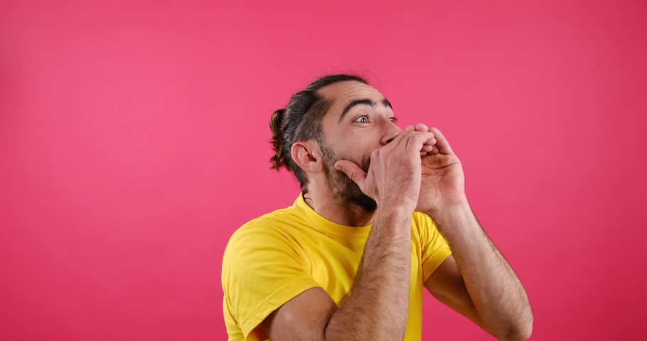 Man whispering secret over pink background | Shutterstock HD Video #1084953451