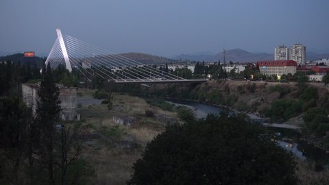 PODGORICA, MONTENEGRO - SEPTEMBER 15, 2021: Early morning view on Millennium Bridge and Moraca river in Podgorica, Montenegro. Editorial, 4K. Contains binaural audio