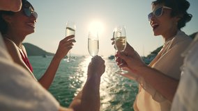 4K Group of man and woman friends enjoy party drinking champagne together while catamaran boat sailing at summer sunset. Male and female relax outdoor lifestyle on sail yacht tropical travel vacation - Powered by Shutterstock - Get 15% off with code: PIKWIZARD15