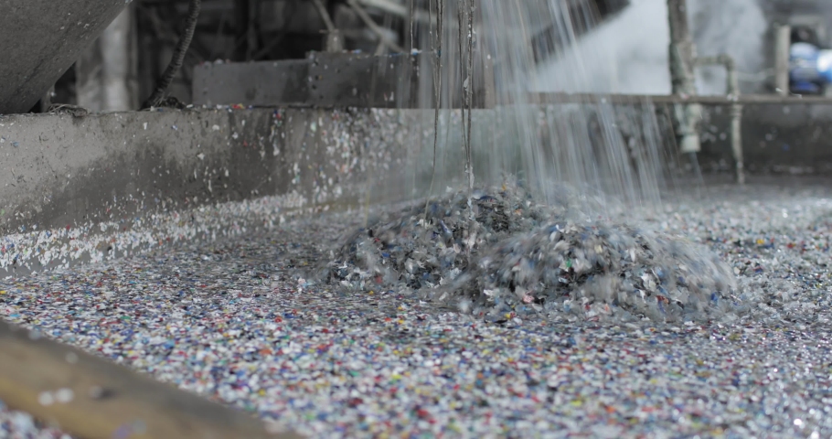 Recycling plastic by dissolving in a metal container using hot steam. A large amount of crushed plastic is drowned in a special liquid. Solid waste processing stage. Environmental protection concept. | Shutterstock HD Video #1084960639