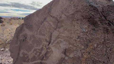 Ancient indigenous petroglyphs on rock in Bandelier National Monument