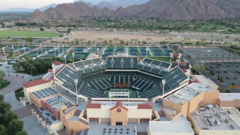 Empty Seats At Indian Wells Tennis Garden Stadium With Tennis Courts In Background. - aerial