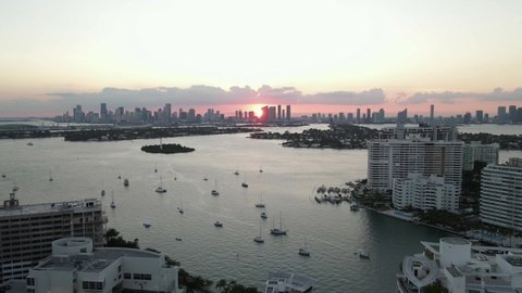 Sunset Biscayne Bay aerial and downtown Miami buildings in setting sun