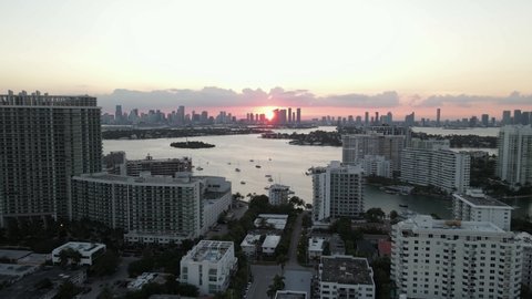 South Beach sunset aerial with downtown Miami beyond Biscayne Bay
