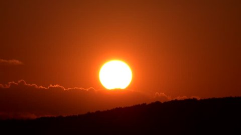 4K Timelapse of sun silhouette go down at sunset over mountain forest 