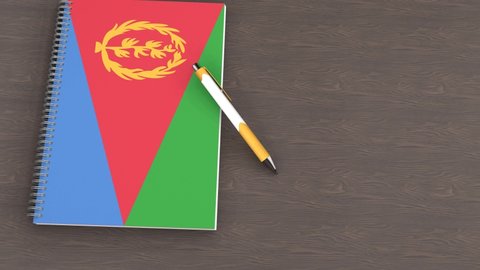 A notebook with the flag of Eritrea and a lying pen