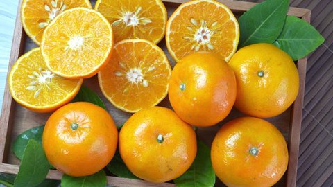 Mandarin Orange fruit  on wooden table.Taiwan Tangerine Orange with slices on wooden tray. 