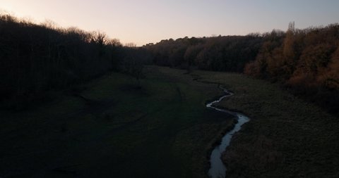 Aerial shot of a lonely river next to the Loire Valley by sunset in Touraine, France.
