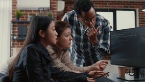 Mixed team of software engineers brainstorming ideas for new cloud computing user interface looking at running code on computer screens. Programmers collaborating on group project compiling algorithm. - Powered by Shutterstock - Get 15% off with code: PIKWIZARD15