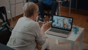 Retired adult talking to family on online teleconference, using laptop in living room. Retired woman calling daughter and little girl on remote videoconference call on internet connection. - Powered by Shutterstock - Get 15% off with code: PIKWIZARD15