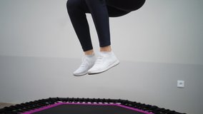 athletic girl are engaged in jumping on sports trampoline Video HD