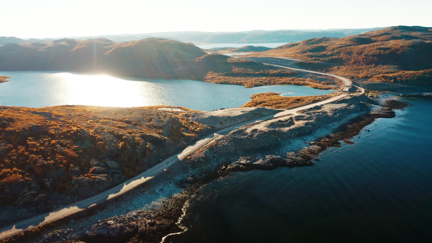 Arctic aerial. Aerial view of the Barents Sea coastline with road and beach. Arctic Tundra near the town of Teriberka in Russia Royalty-Free Stock Footage #1084981174